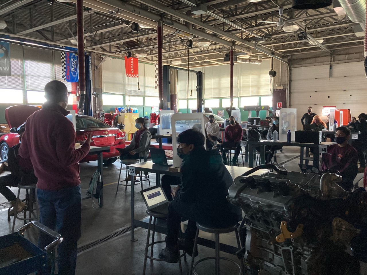 a full view of the auto shop and lots of students sitting at desks