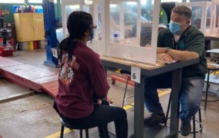 student sits across from an employer and interviews