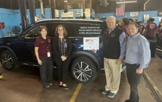 Local Nissan dealership representatives standing in front of donated car to Bullard-Havens auto program.